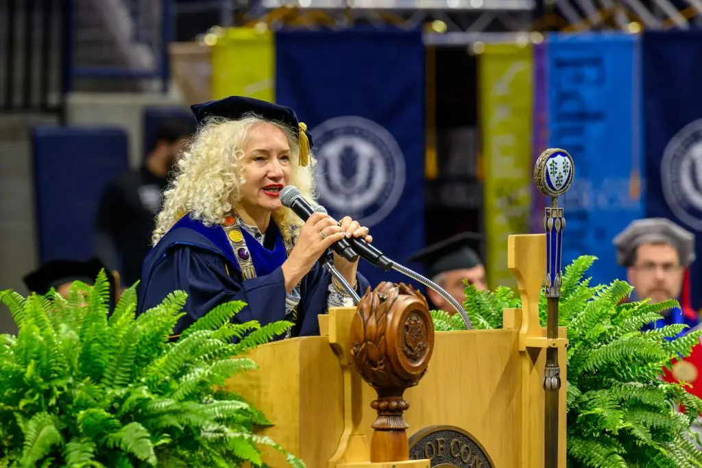 UConn President Maric speaking at commencement into a mic