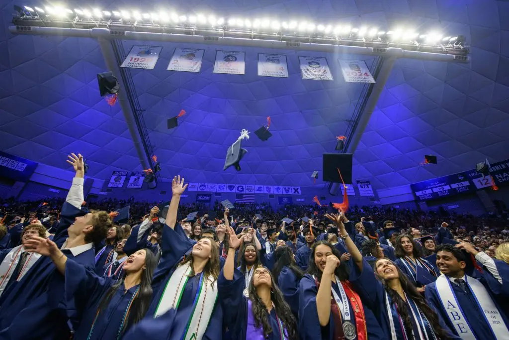Graduates tossing their hats at commencement