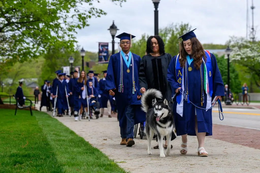 Jonathan XV leads the Commencement procession to Gampel Pavilion