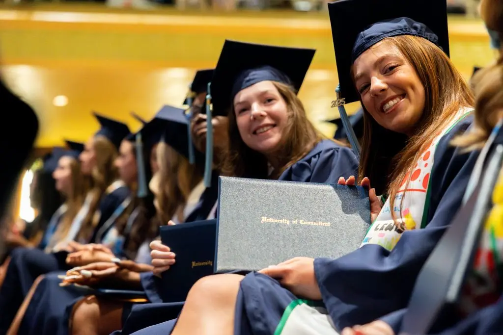 Graduates showing off their diploma