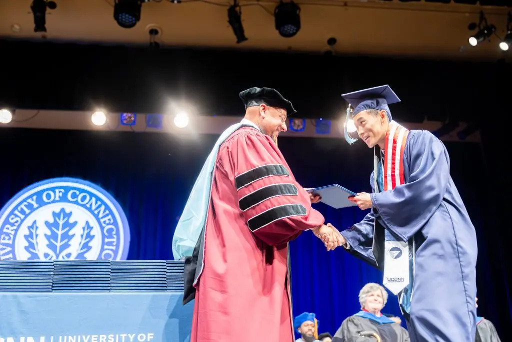 Graduate shaking hands with the Dean