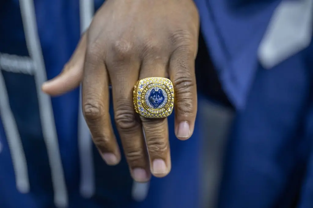 A hand showing off a husky championship ring