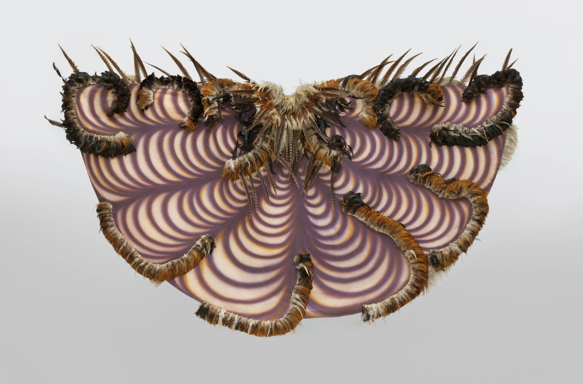 feathered and spray-painted half-circle painting, like cloak
