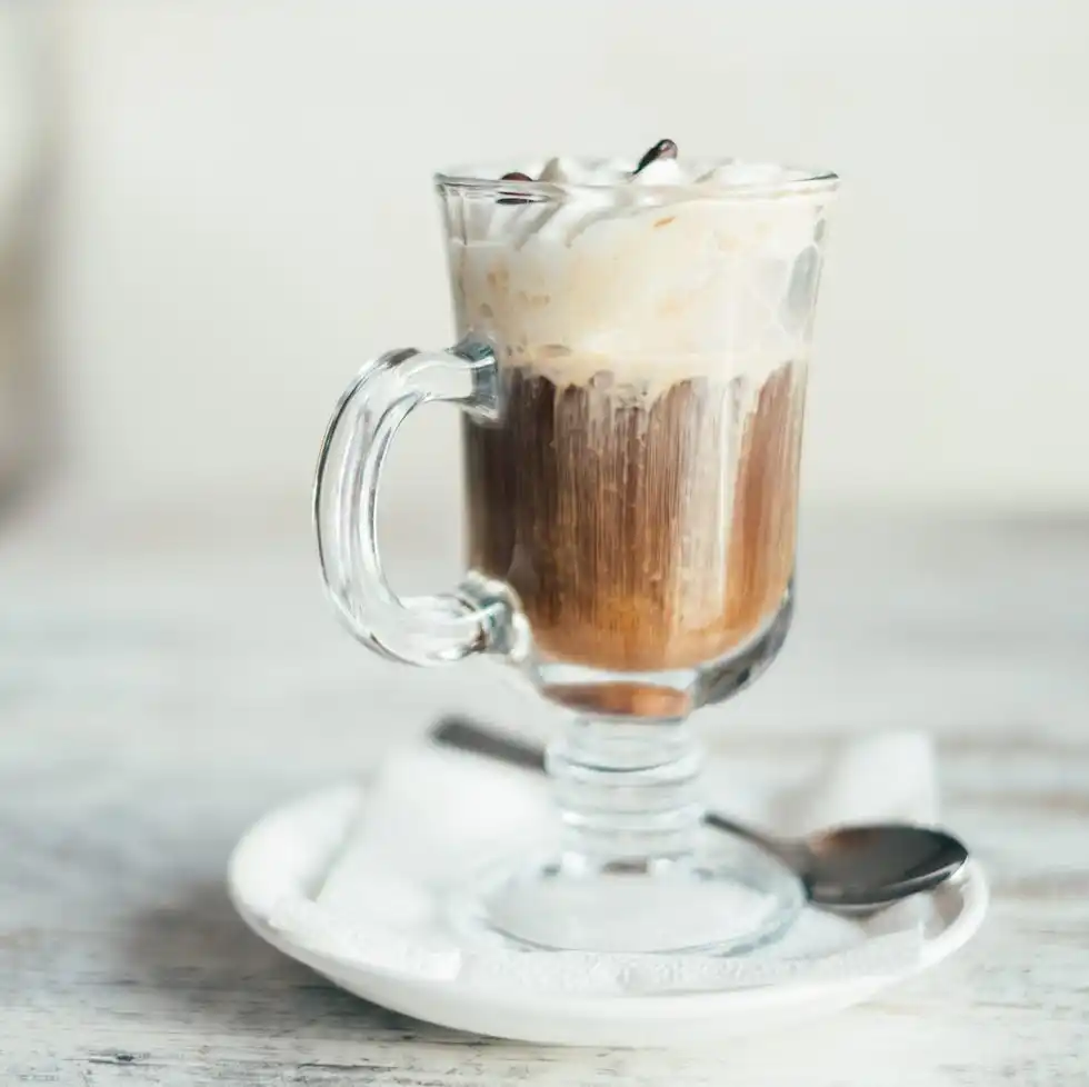 close up of an irish coffee on a wooden table