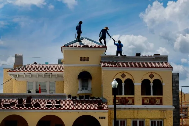 Roofers at the Hollywood Arts and Culture Center continue work on Friday, September 20, 2024. The current 1924 Mediterranean Revival architecture of the facility will be enhanced with the construction of a new, nearly 5,000-square-foot arts education wing that will be distinct and contemporary with a modern gleaming façade and swooping rooftop. (Mike Stocker/South Florida Sun Sentinel)