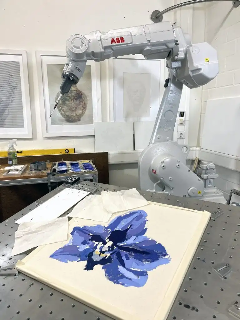 a robotic arm painting a flower