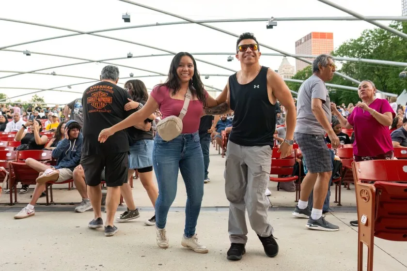 Crowd members dance as Fruko y Sus Tesos performs during ¡SÚBELO! Fest at the Jay Pritzker Pavilion in Millennium Park, Thursday, July 18, 2024.