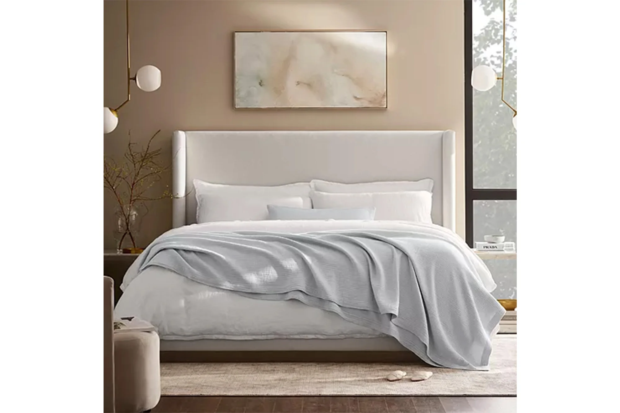 A bed with a luxe throw on it