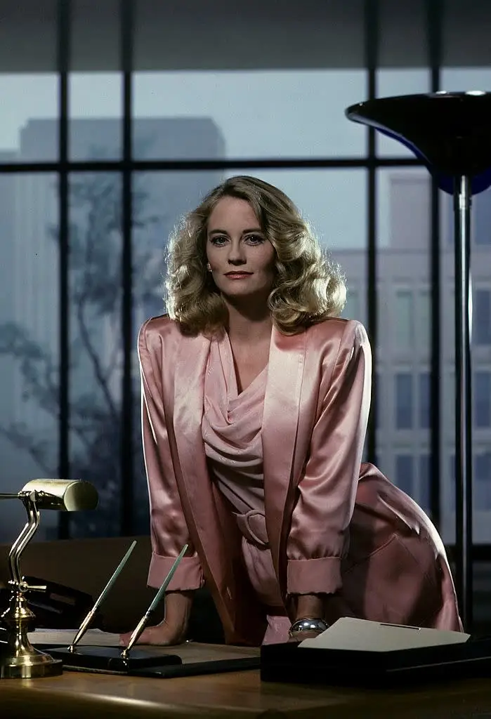 Cybill Shepherd wearing a blazer with oversized shoulder pads on the set of Moonlighting