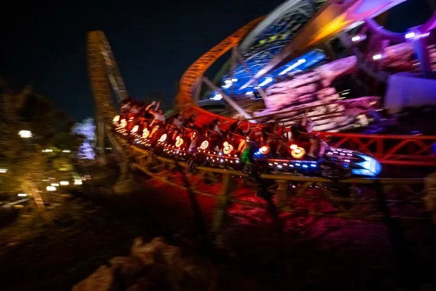 Guests take a ride on the Stardust Racers dueling coaster as it's lit up at night at Universal Epic Universe. (Patrick Connolly/Orlando Sentinel)