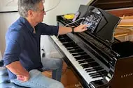 Jon Suder demonstrates how his Steinway Spirio, a souped-up acoustic player piano, works in...