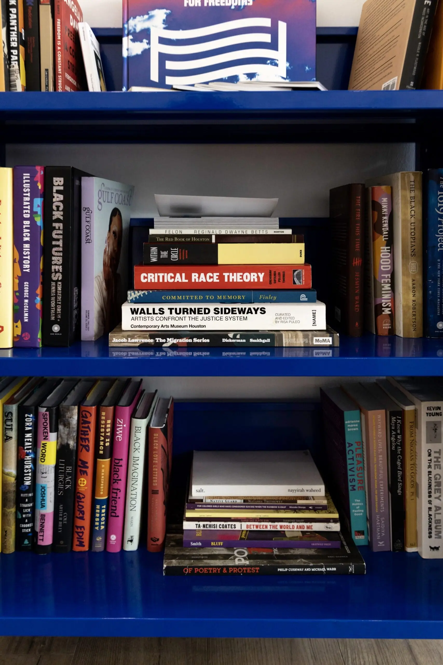 a close up of a blue library cart with books on it
