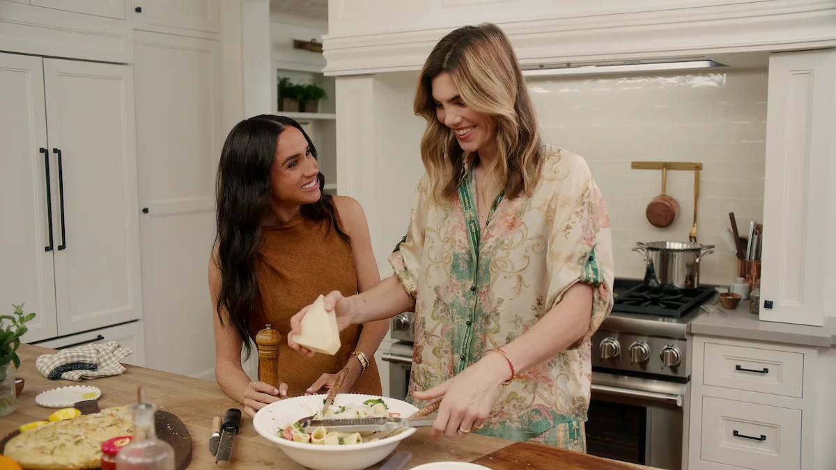 Meghan and Delfina Figueras preparing a salad in the kitchen together.