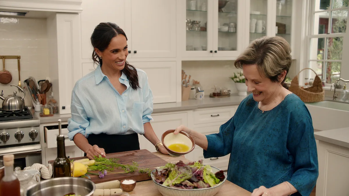 Meghan and Alice Waters preparing a salad in the kitchen.