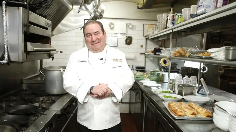 Emeril Lagasse in kitchen wearing chef's coat