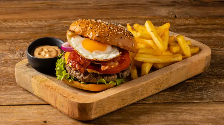 bacon egg burger served with fries