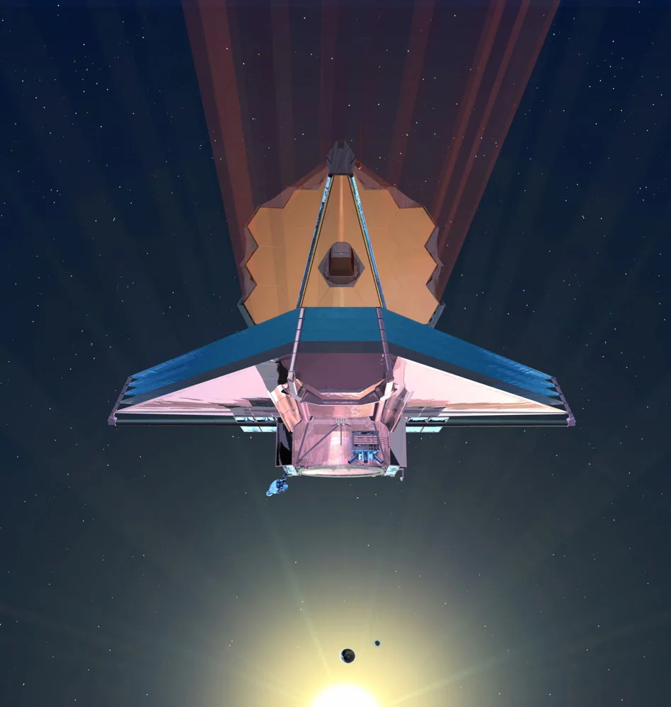 a spacecraft floats in space. it consists of a roughly triangular body beneath a hexagonal mirror made of smaller gold hexagonal mirrors