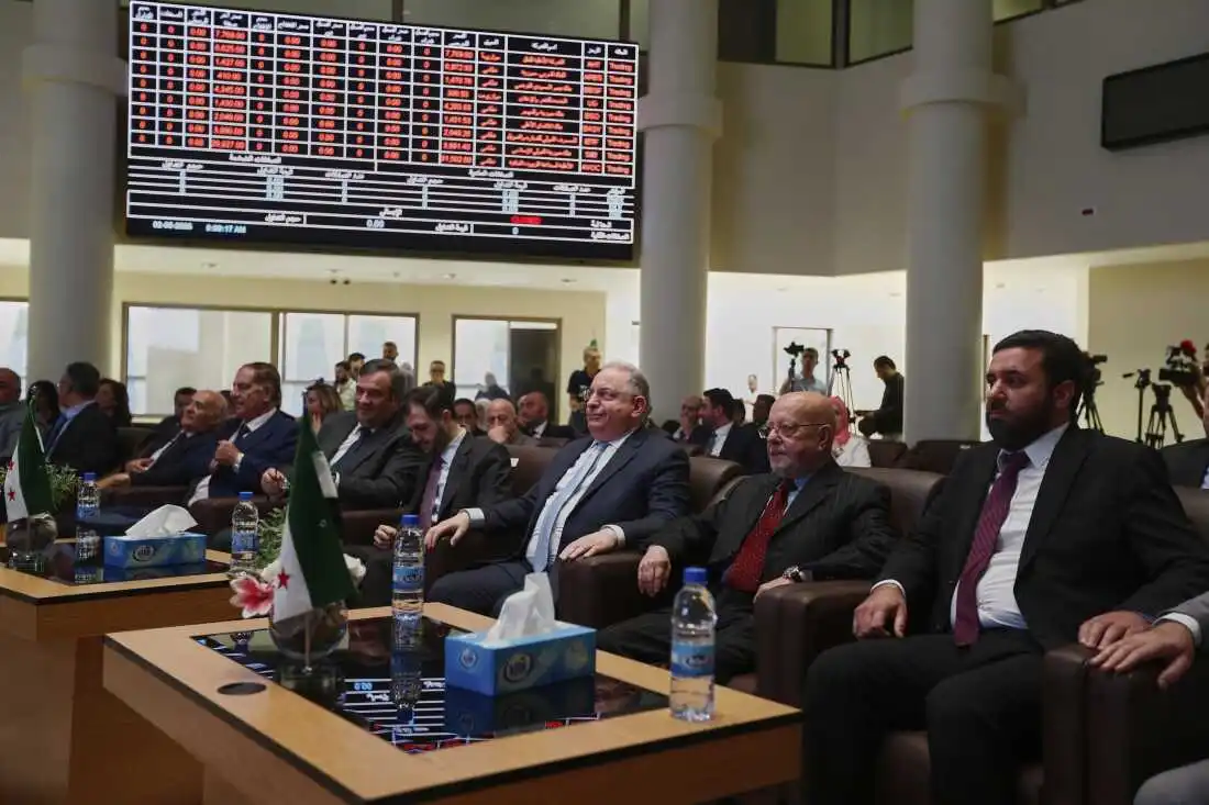 Syrian Finance Minister Mohammed Yisr Barnieh, center, attends the opening ceremony at the Damascus Securities Exchange in Damascus, Syria, Monday, June 2, 2025. (AP Photo/Omar Sanadiki)