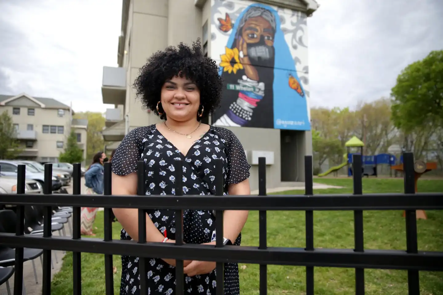 Angela Gonzalez, a muralist who is know as Agonza, in front of her mural located at the Hartford Park housing development.