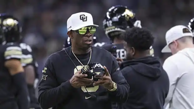 Colorado Buffaloes head coach Deion Sanders walks on the field between plays during the first quarter against BYU Colorado Buffaloes head coach Deion Sanders walks on the field between plays during the first quarter against BYU