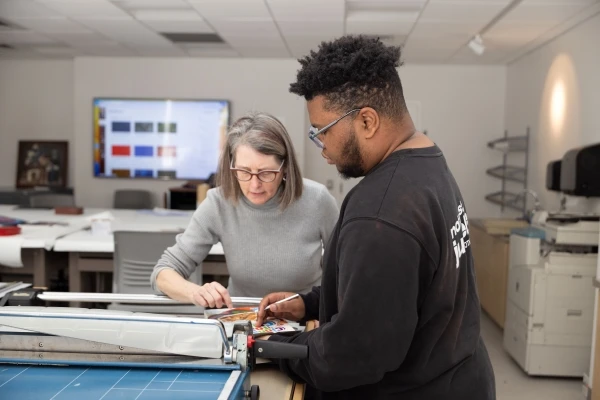 Student and professor working together at a table