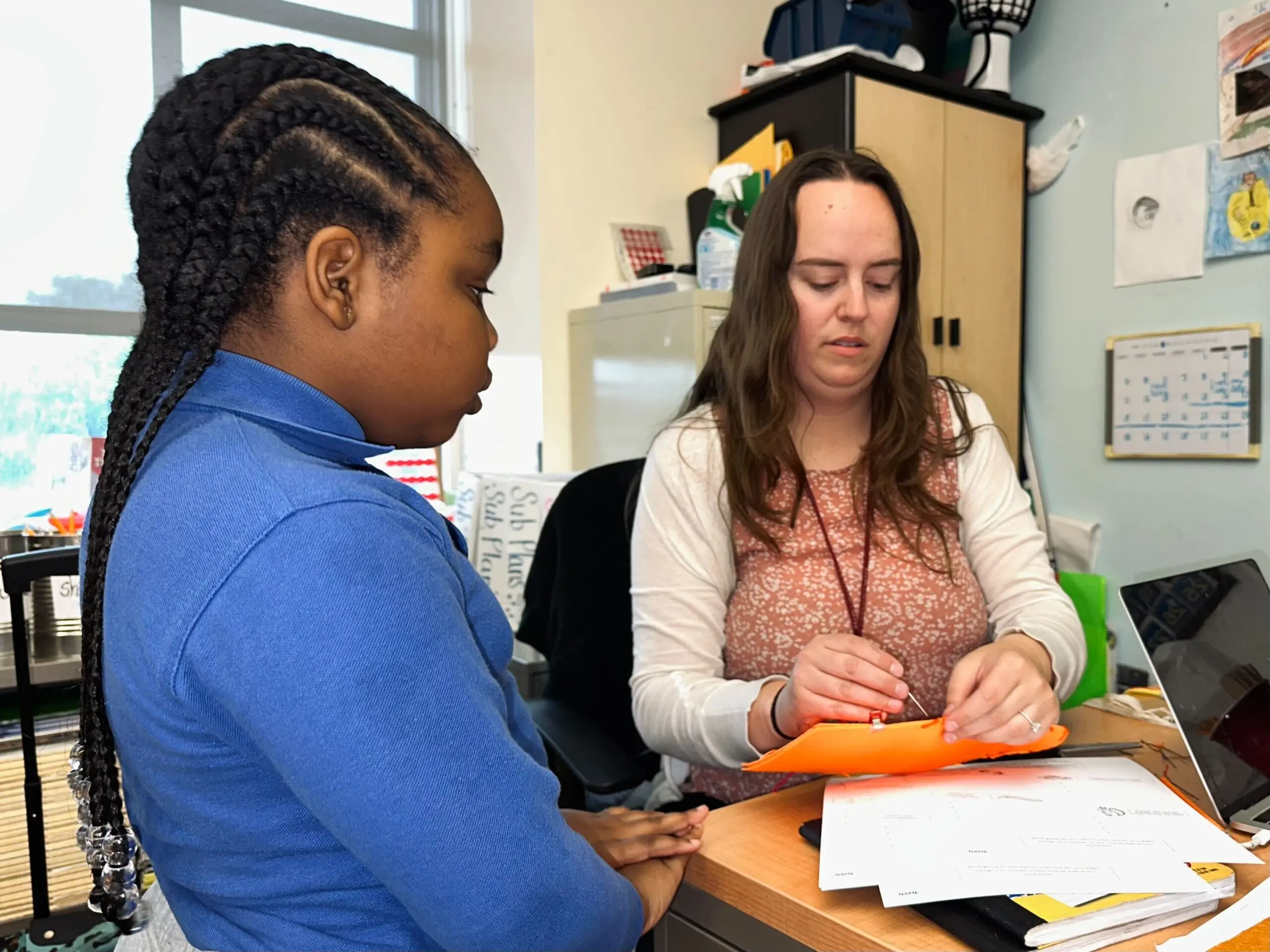 Emma Salisbury helps a student with a puppet