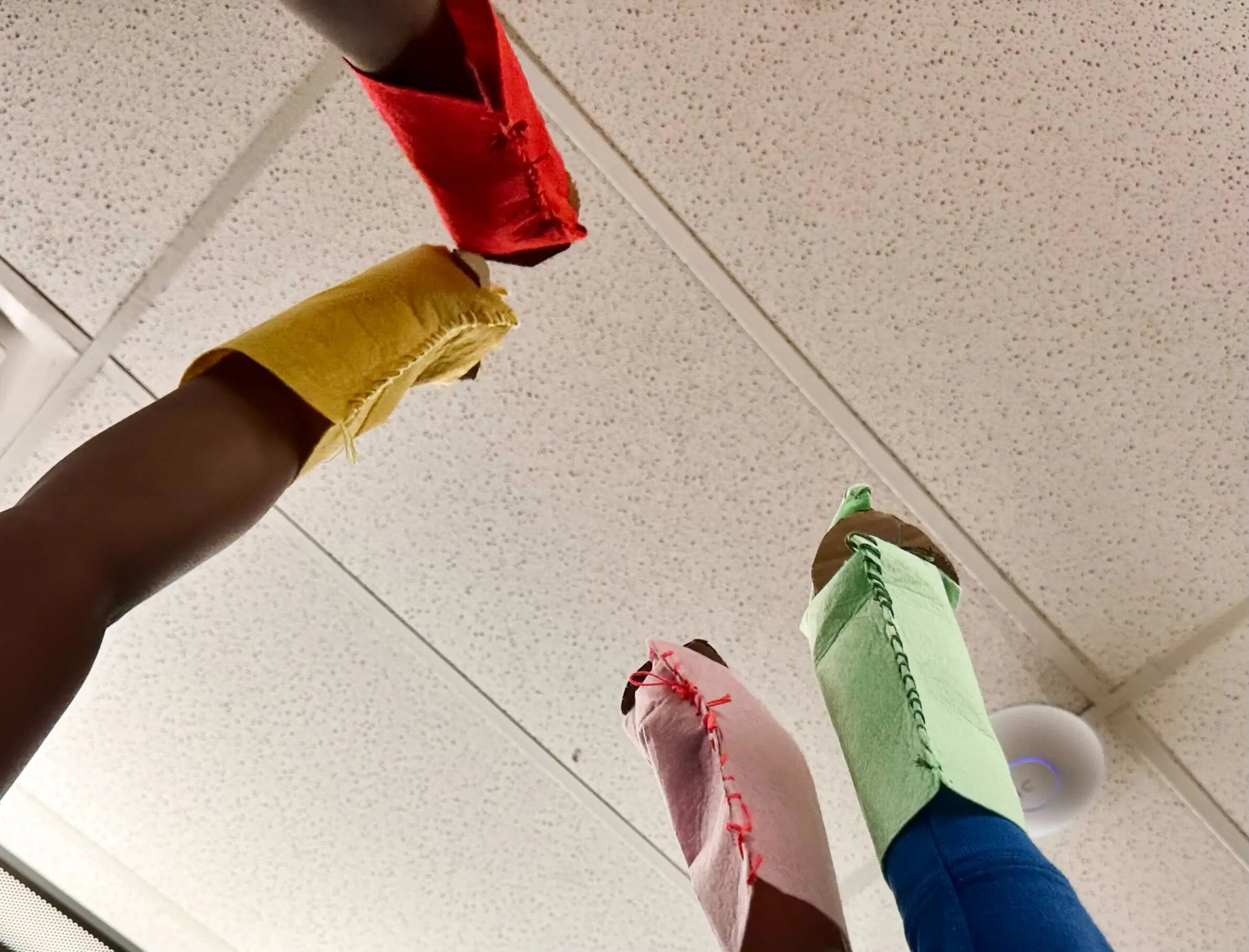 four puppets raised in the air