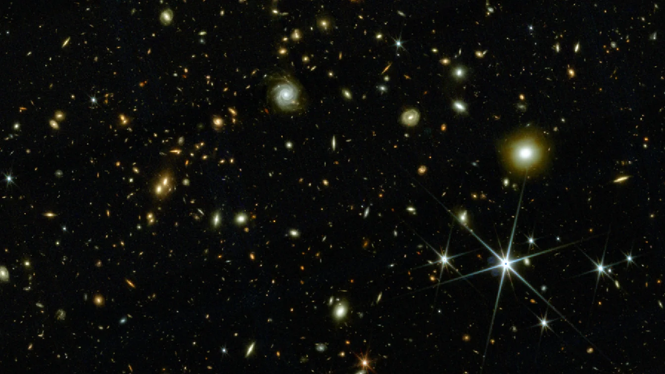 A bunch of galaxies on a dark section of sky.