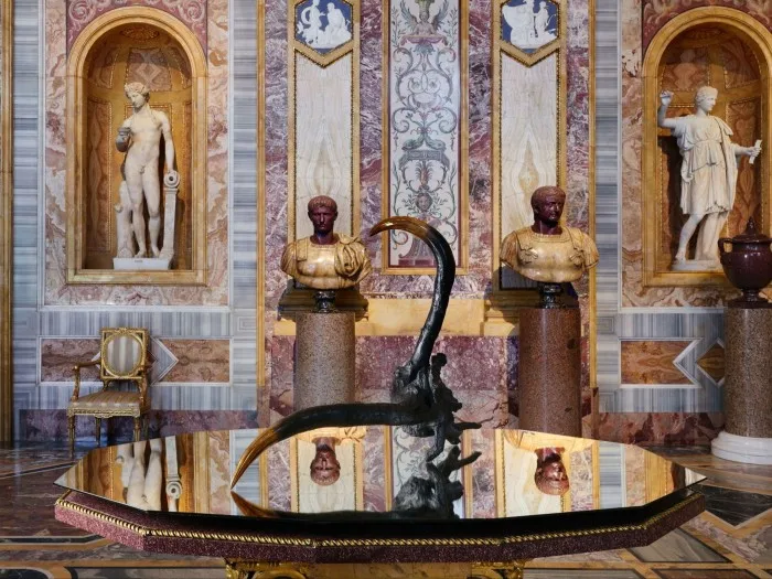 Horn-like object on a table in a grand room