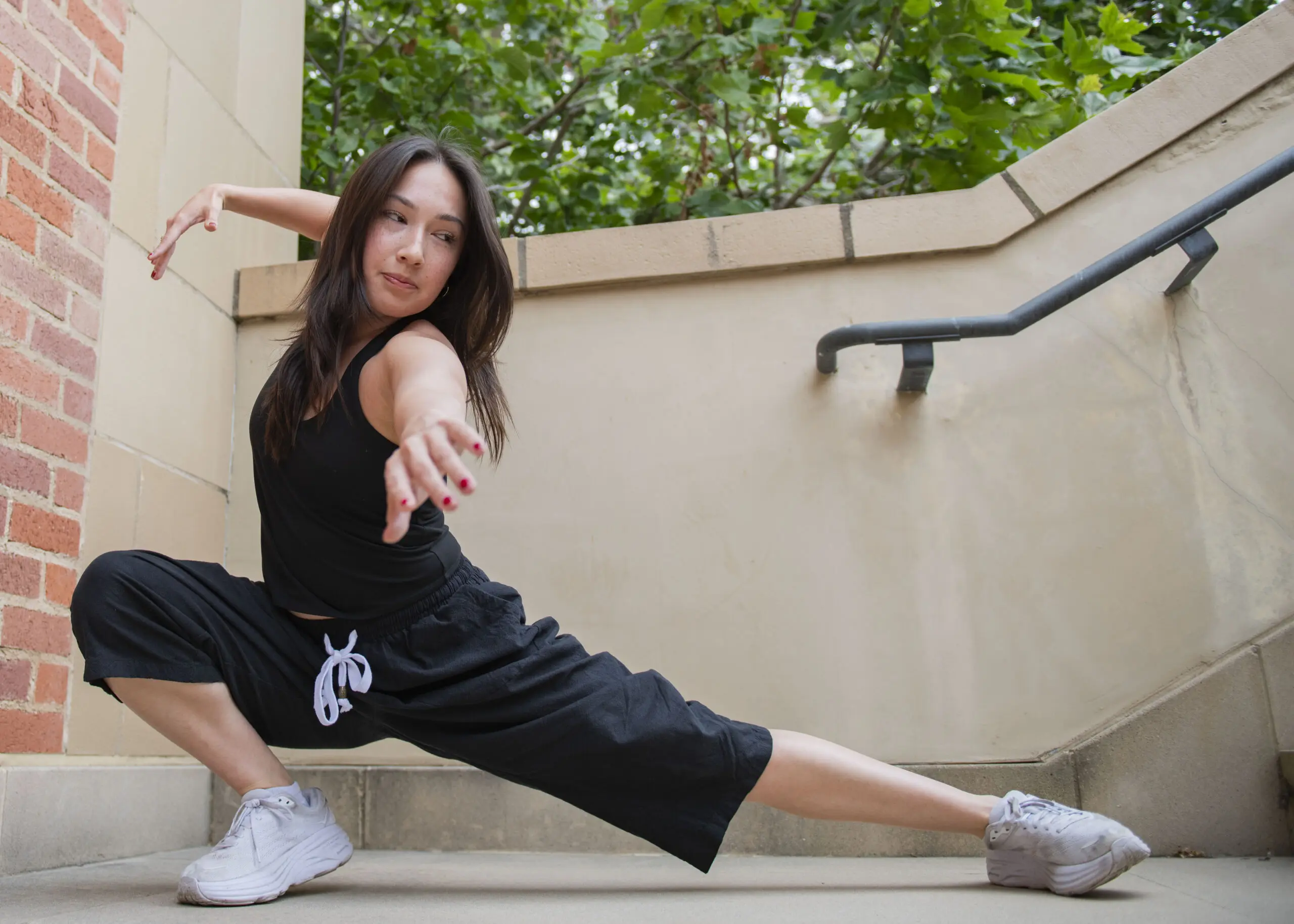 Photographed is Bruce in a ground-level pose, with her arms reaching out while looking to the side. The student said she encourages other dancers to build connections with peers and mentors as she said a great part of her growth as a dancer can be attributed to the dance community at UCLA. (Isabella Appell/Daily Bruin)