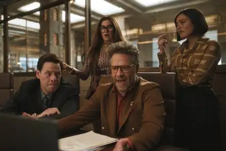 Two white women looking quizzical stand behind two white men, the one on the right seeming like he is about to say something