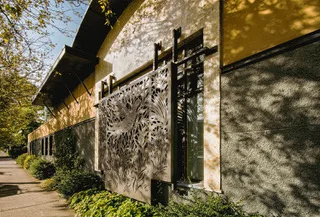A screen across an exterior wall of Havurah Shalom, which connects two concrete former warehouse spaces. Photo: Bruce Forster