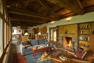 Posts and beams and other wood elements from a pair of dismantled Yamhill County barns bring Northwest warmth to the Columbia Gorge house's interior. Photo: Bruce Forster