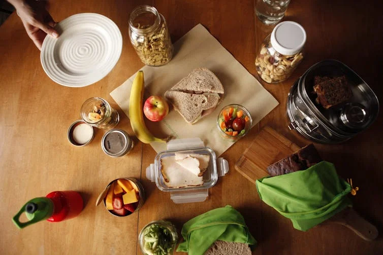 Foods and containers seen on a table.