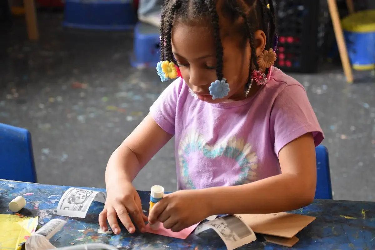 A child using stamps to paint an art project at the Settlement Music School Kaleidoscope Preschool Arts Enrichment Program in Philadelphia. (Meg Looby/Settlement Music School)