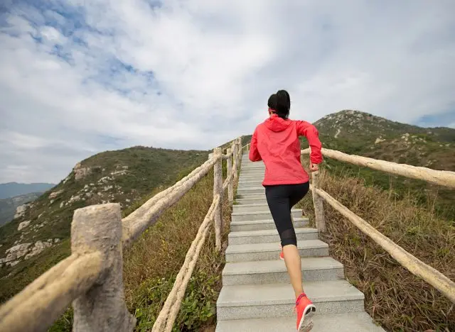 woman running up stairs, mountain outdoors