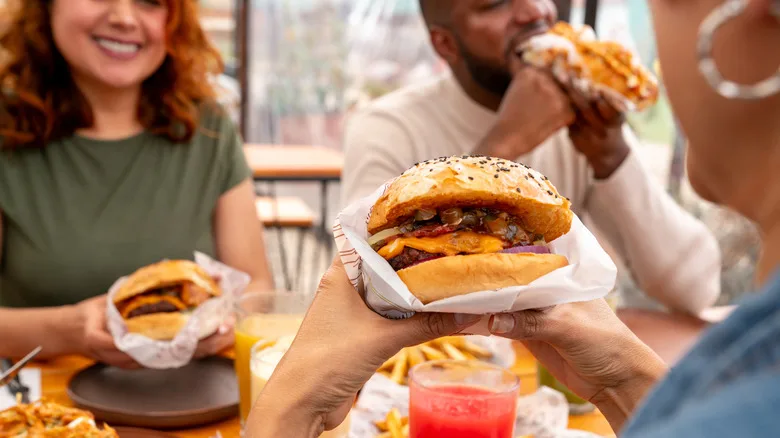 Friends enjoying their burgers at a resturant