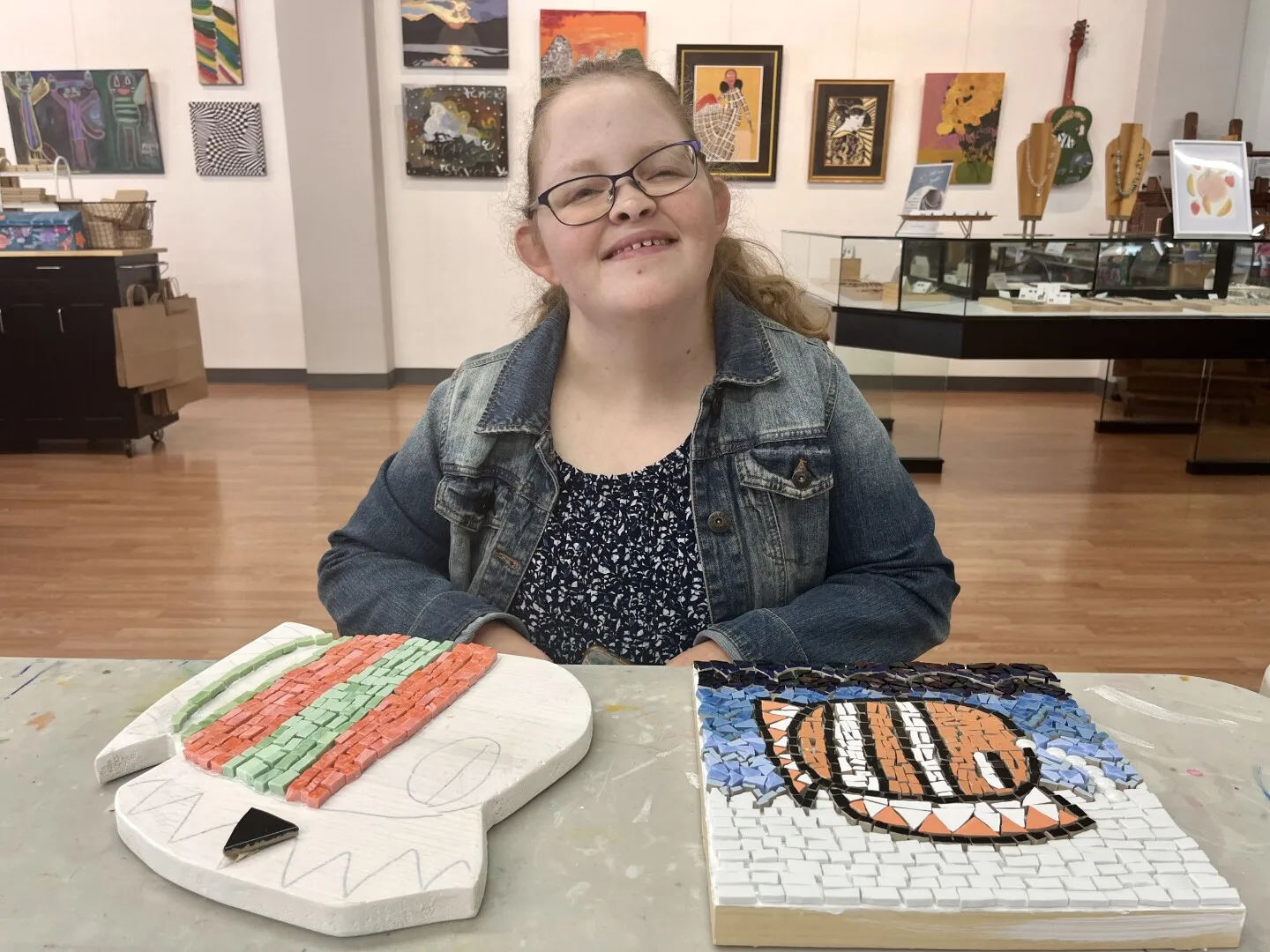 Lauren Heim poses with her mosaics inside of Sophie's Gallery, June 5, 2025.