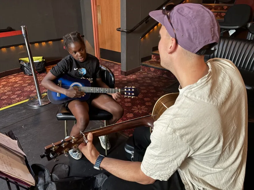 11-year old Sam sits facing her guitar teacher, Adam Petty, during a recent lesson. 