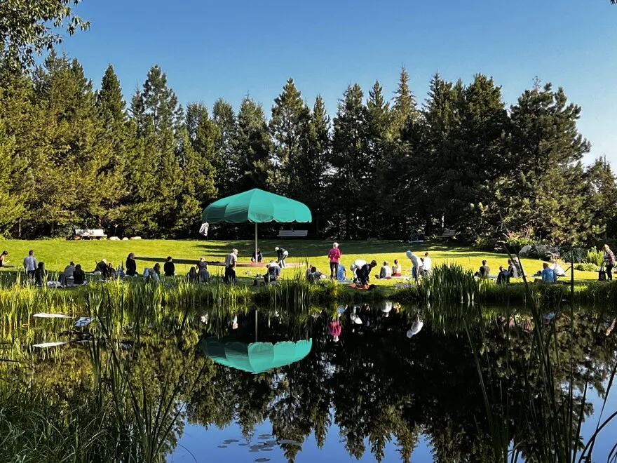 People lounge on the banks of the Yampa River on a sunny day in Steamboat Springs.  