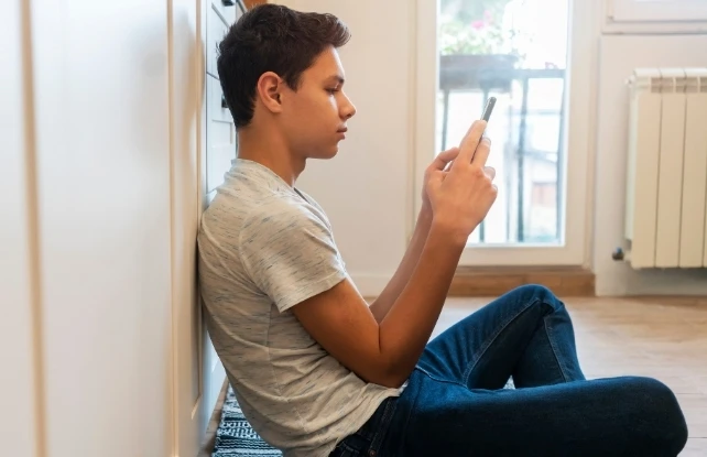 teen boy on phone