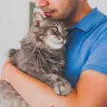 man holding a cat
