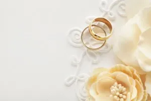 two wedding rings and flowers, wedding invitation