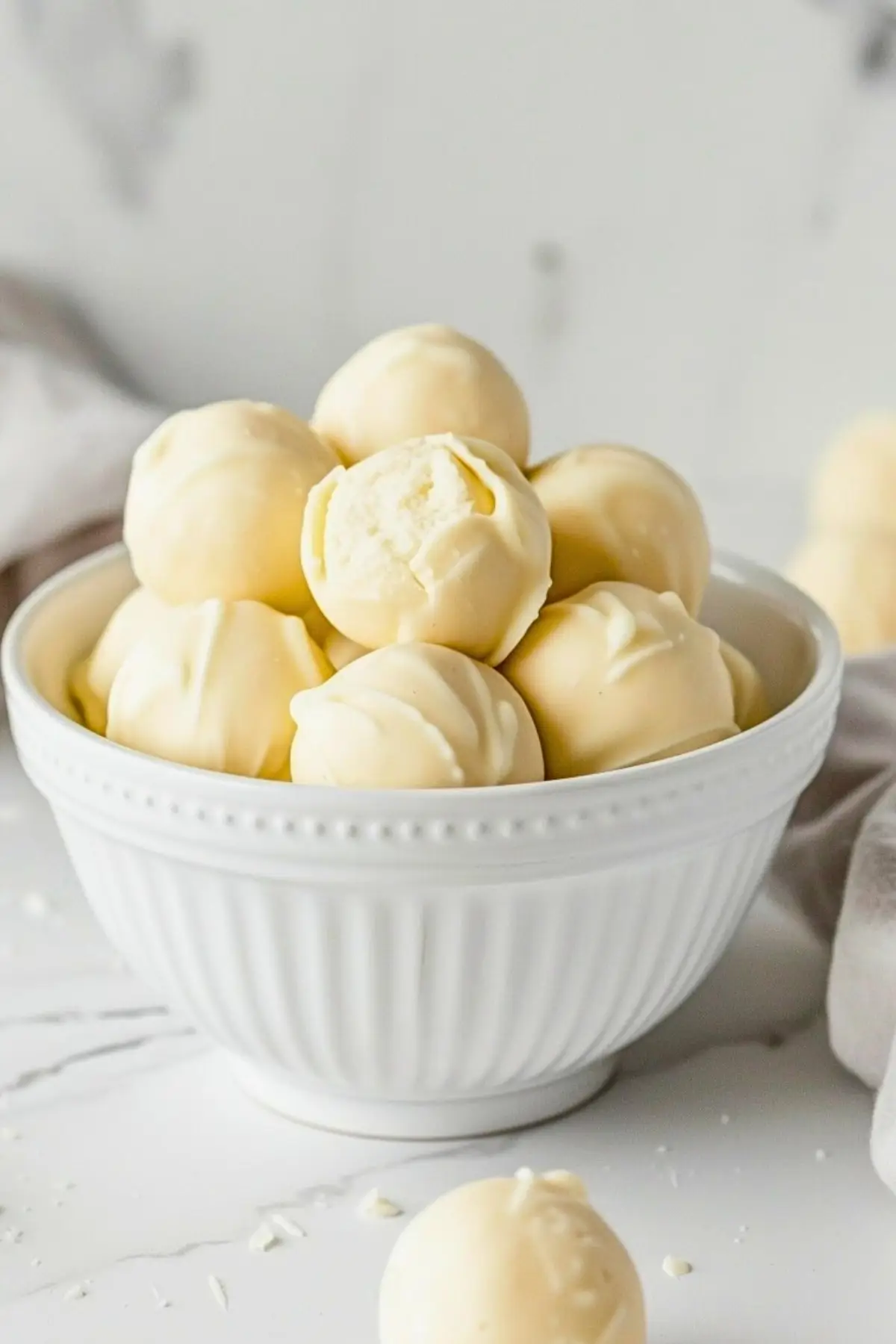 Bunch of white chocolate truffles in a bowl.