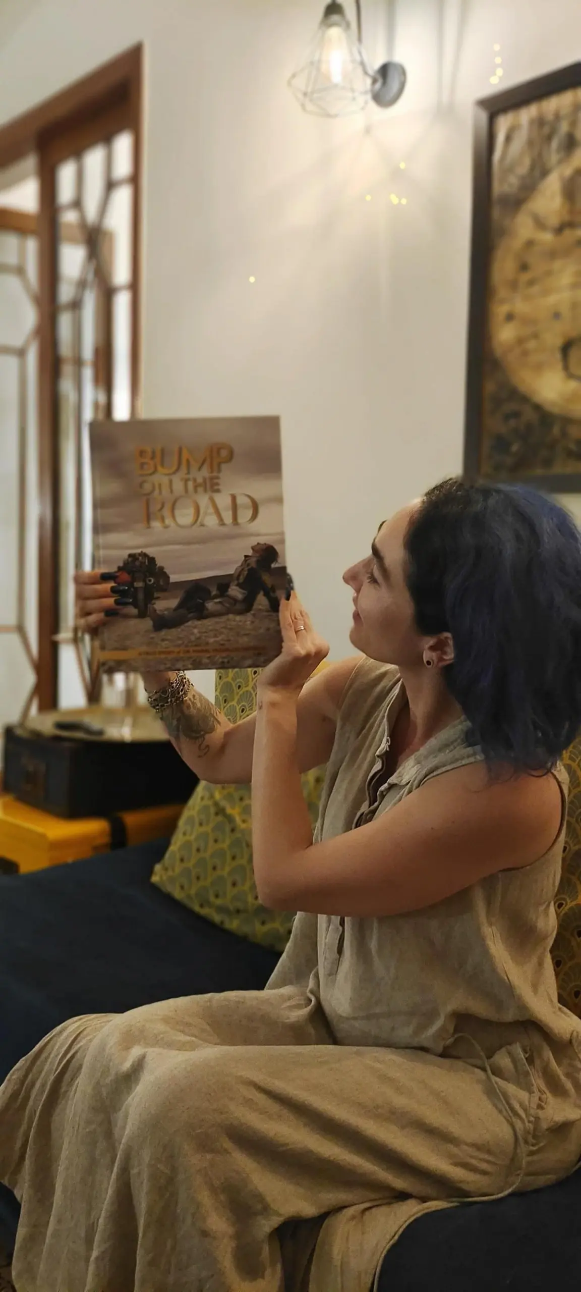 Maral Yazarloo Pattrick with her book, Bump on the Road, that captured her ride which spanned 18 months, covered 7 continents, 64 countries, and 110,000 kilometres