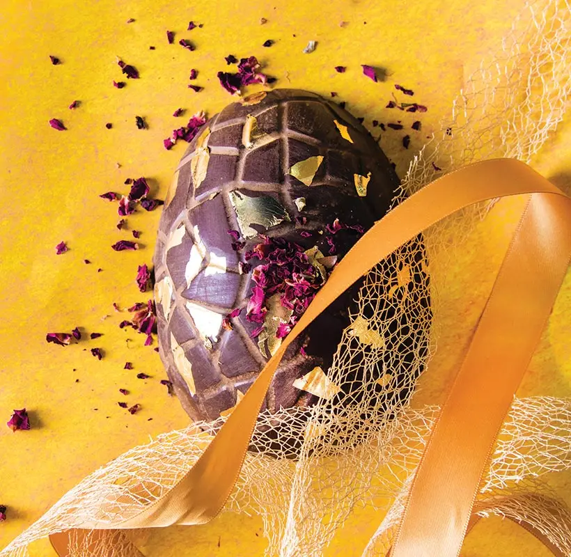 Large raw vegan chocolate easter eggs with edible flower petal and gold leaf decorations