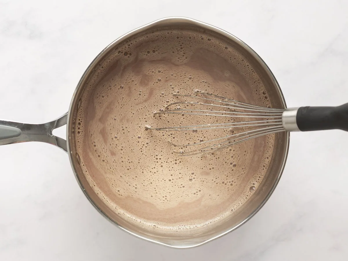 whisking chocolate and vanilla in cream mixture until chocolate is melted