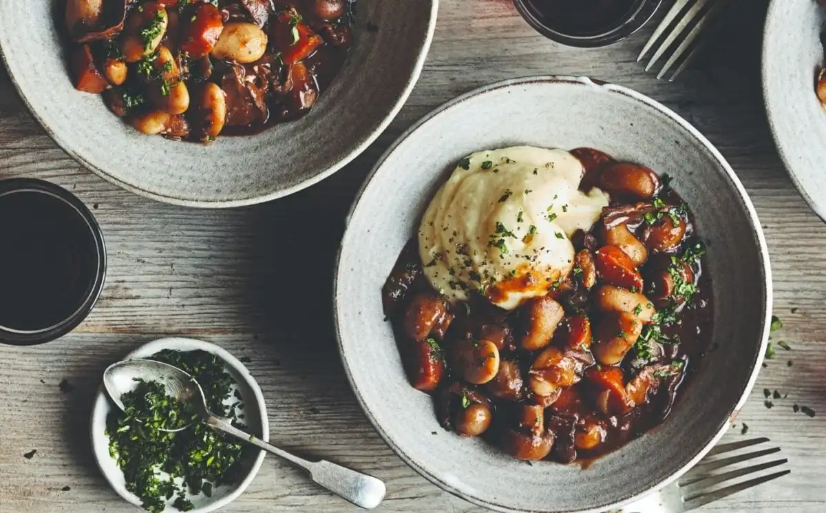 Photo shows two bowls of butter bean-based bourguignon