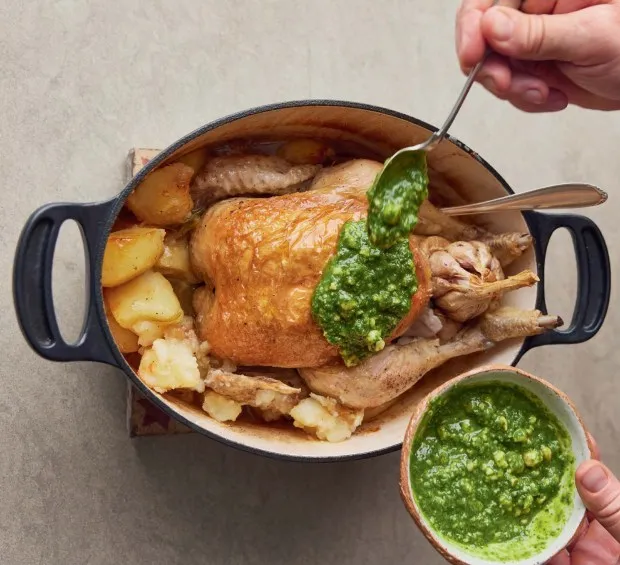 This recipe for Pot-Roast Chicken and Fondant Potatoes topped with an herb-packed salsa was inspired by Chef Jamie Oliver's recent trip to Barcelona, Spain. (Photo by David Loftus)