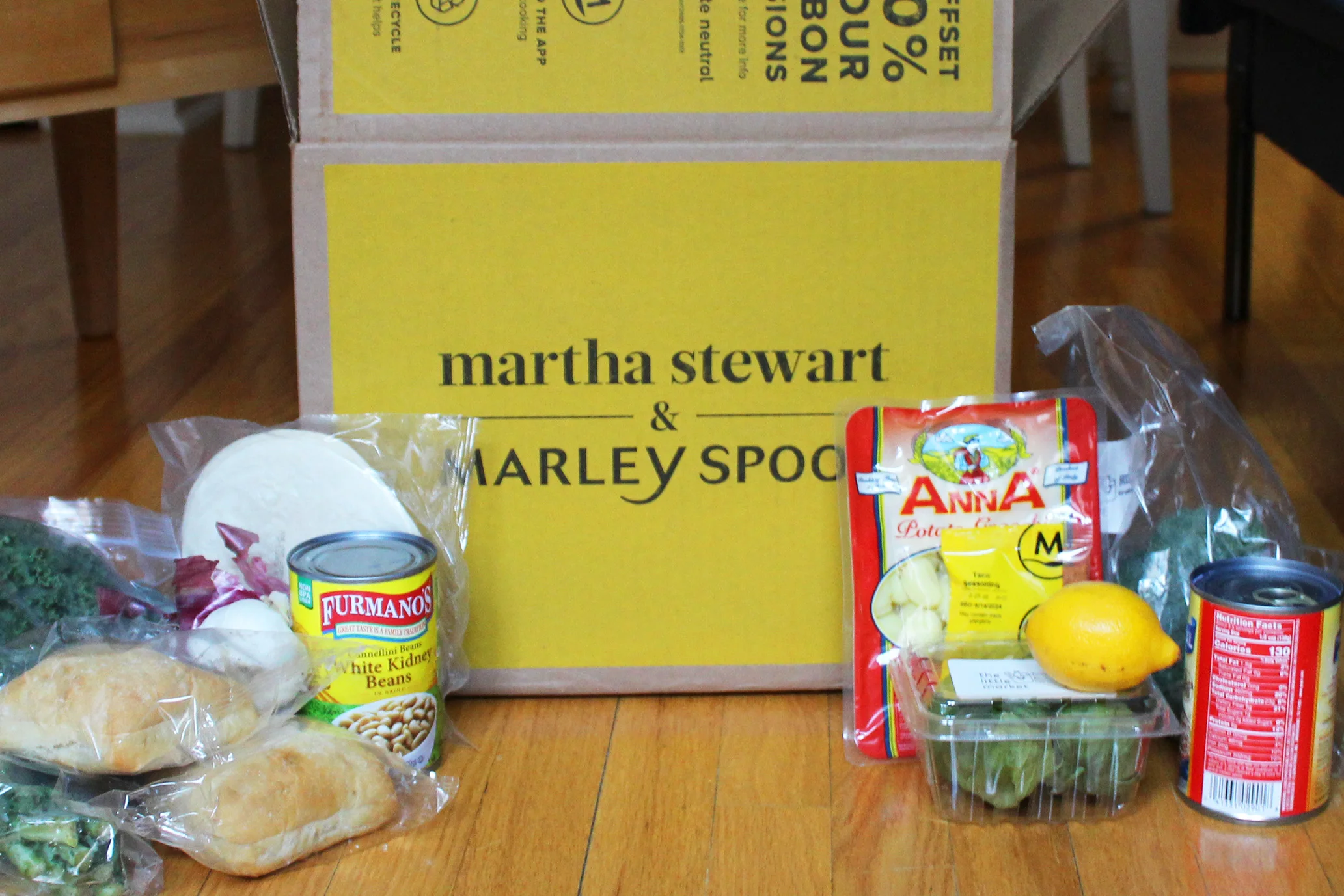 A yellow Martha Stewart x Marley Spoon box with ingredients laied out in front of it